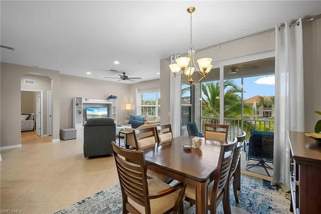 a dining room with furniture a chandelier and a rug