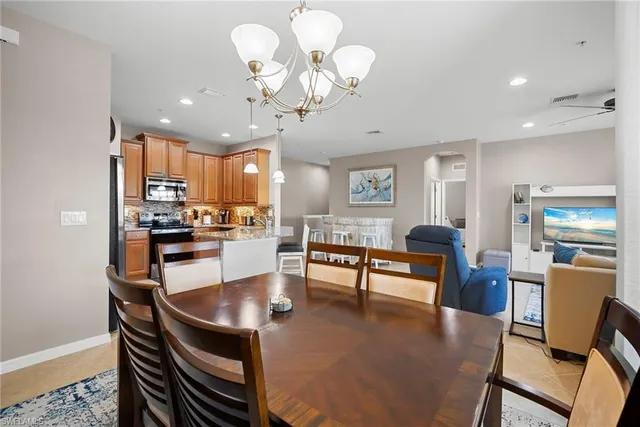 a living room with kitchen island furniture and a chandelier