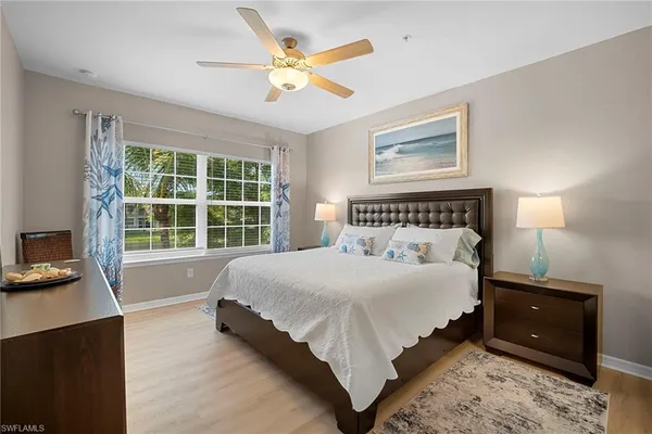 a bedroom with a bed and a large window