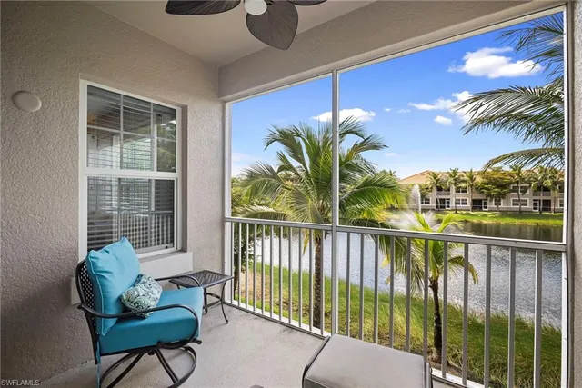 a view of a chairs and table in patio with a small yard