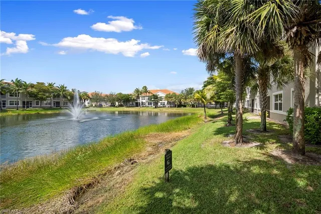 a view of a lake with houses in the background