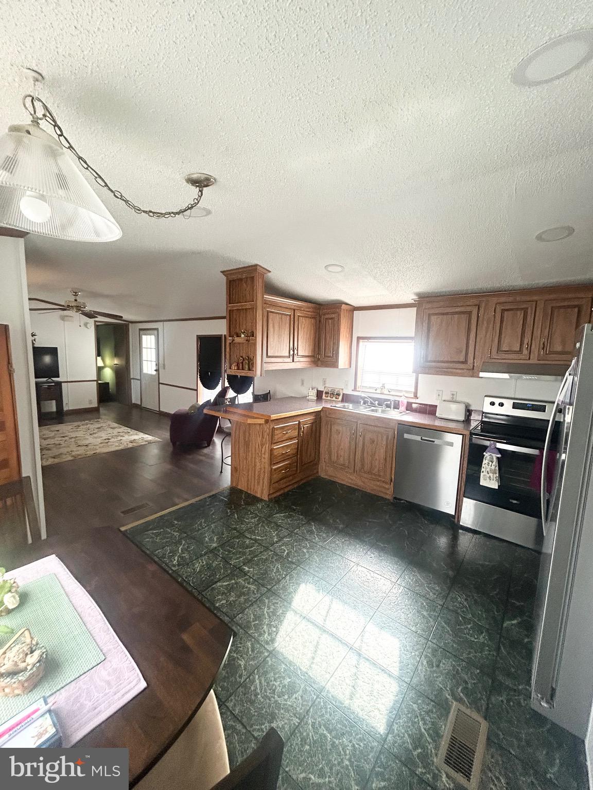 1079 Sage Avenue Reading, PA 19605 - Photo 6 of 12 a kitchen with stainless steel appliances granite countertop a sink stove and cabinets