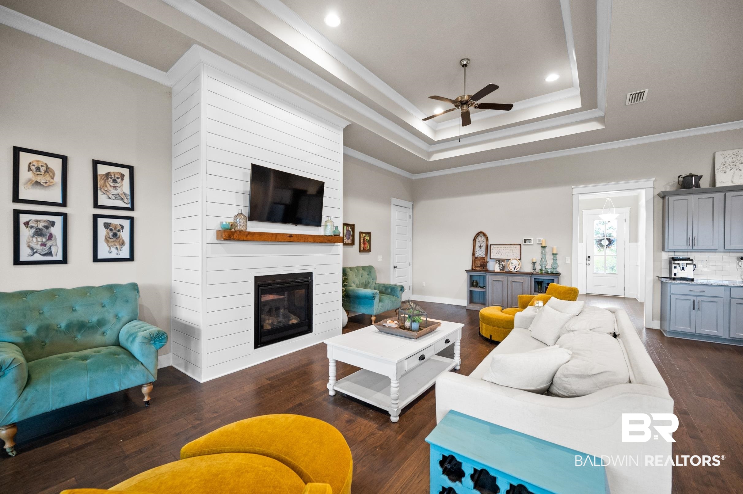 31355 Limpkin Street Daphne, AL 36527 - Photo 38 of 57 Living room featuring a fireplace, crown molding, ceiling fan, and dark wood-type flooring