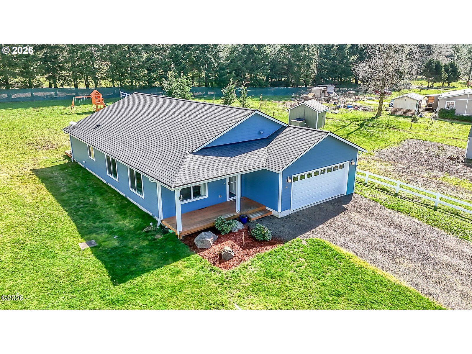 a aerial view of a house with a yard table and chairs