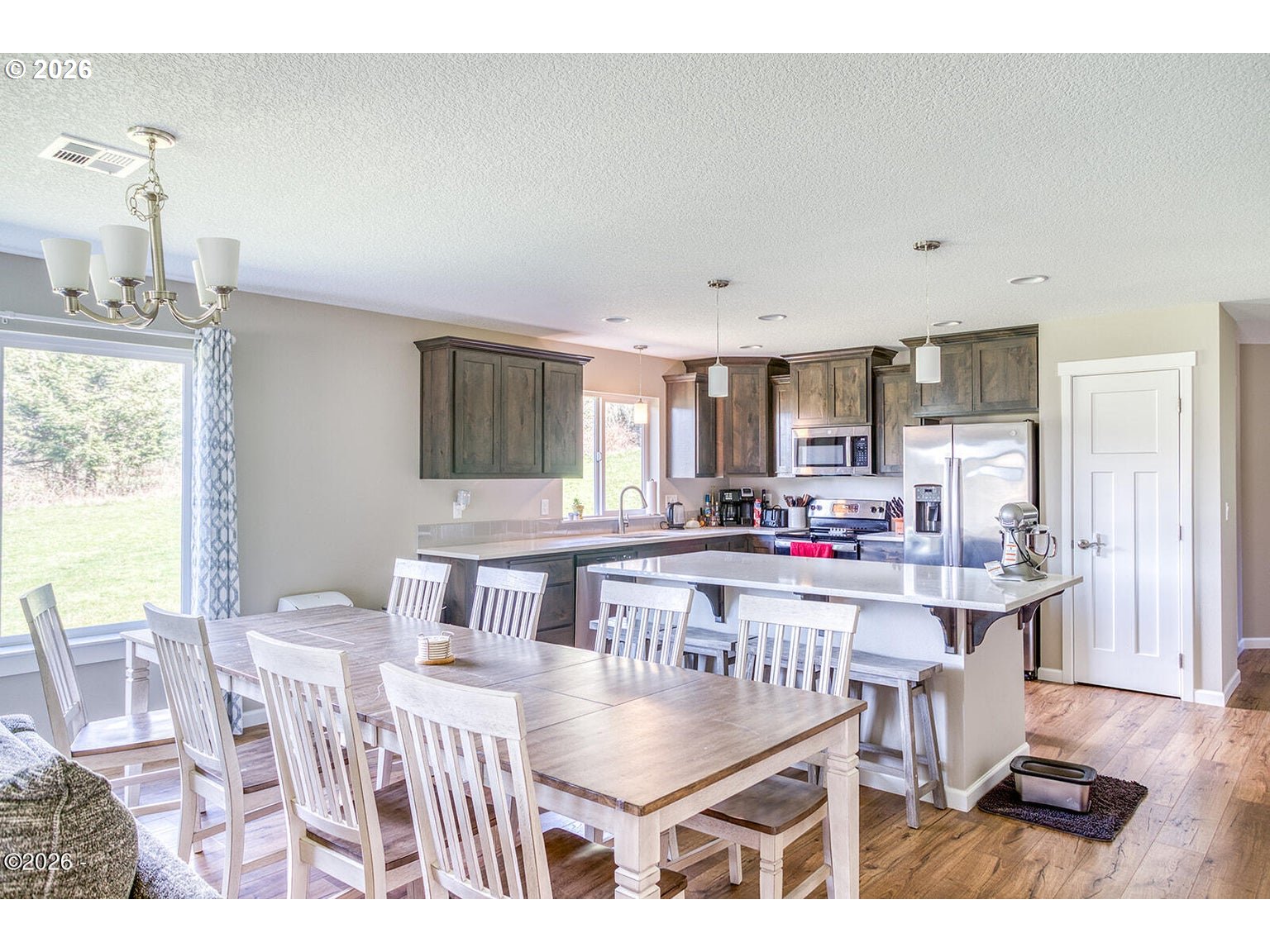 33803 Highway 22 Hebo, OR 97122 - Photo 12 of 40 a room with kitchen island a dining table and chairs