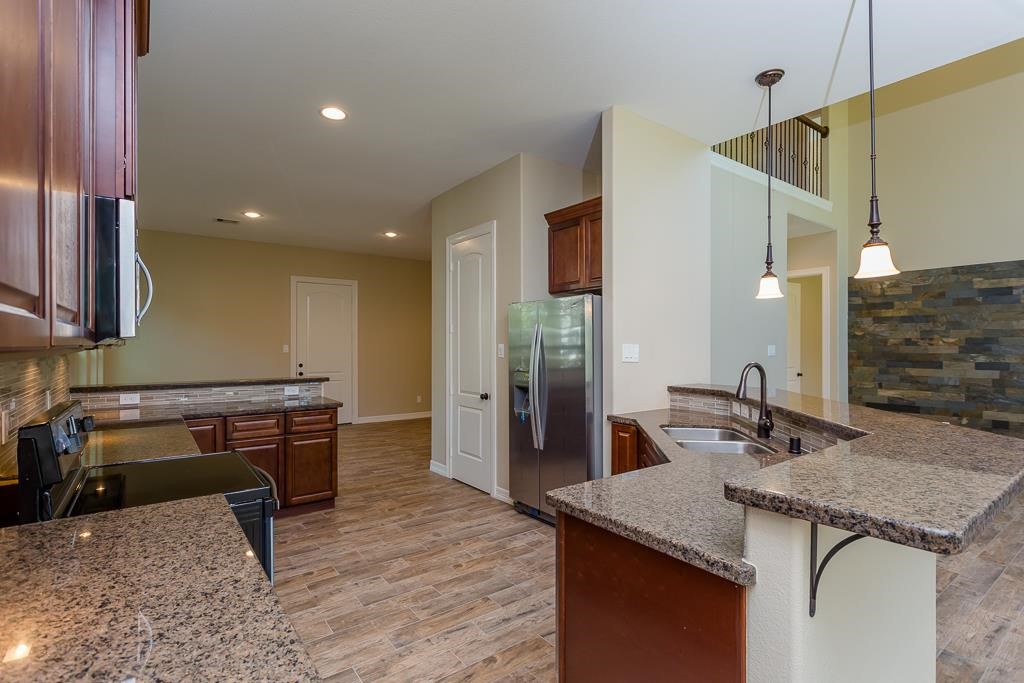 8403 Oak Knot Drive Spring, TX 77389 - Photo 12 of 31 a kitchen with a sink a counter and chairs