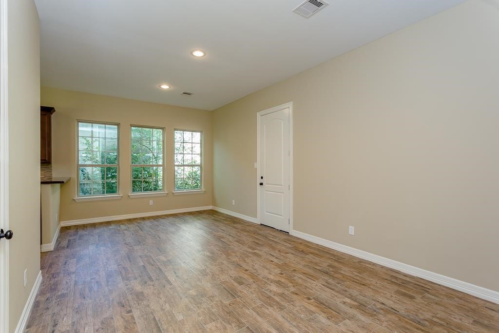 8403 Oak Knot Drive Spring, TX 77389 - Photo 15 of 31 wooden floor in an empty room with a window