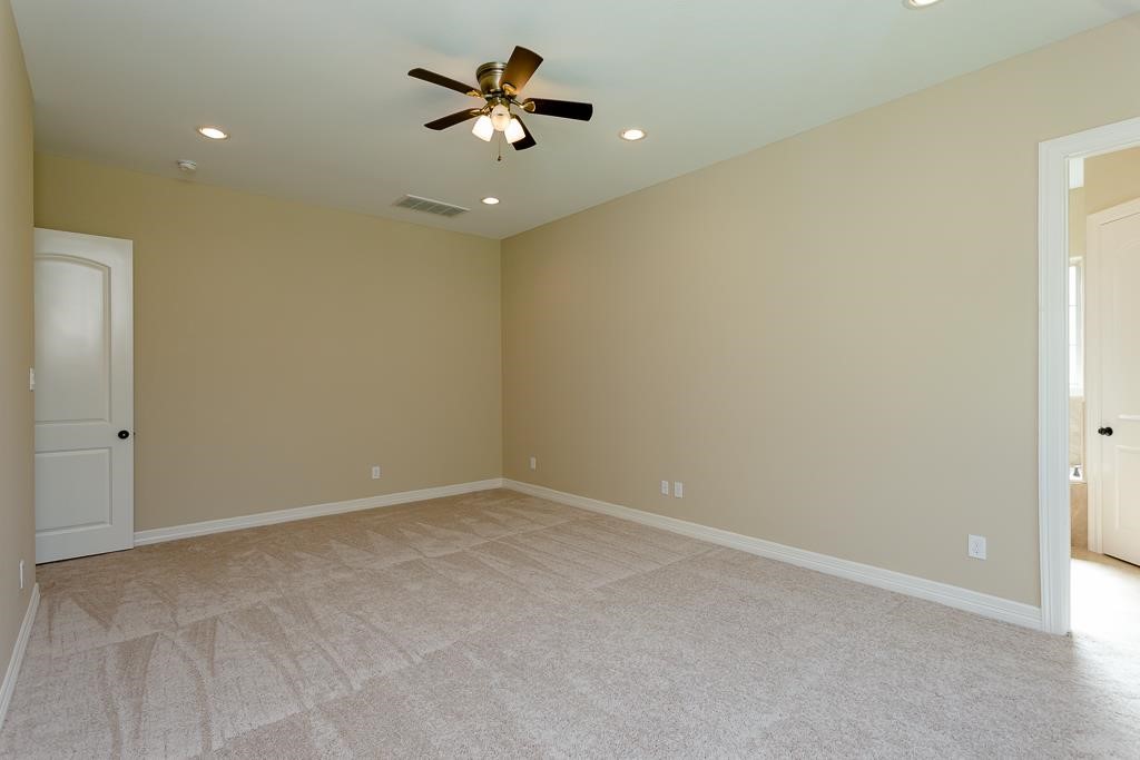 8403 Oak Knot Drive Spring, TX 77389 - Photo 19 of 31 an empty room with a ceiling fan and a window