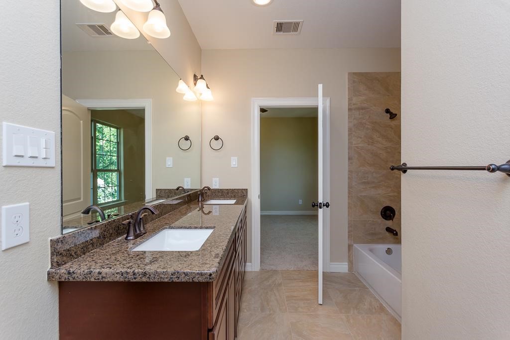8403 Oak Knot Drive Spring, TX 77389 - Photo 26 of 31 a bathroom with a granite countertop sink and a mirror