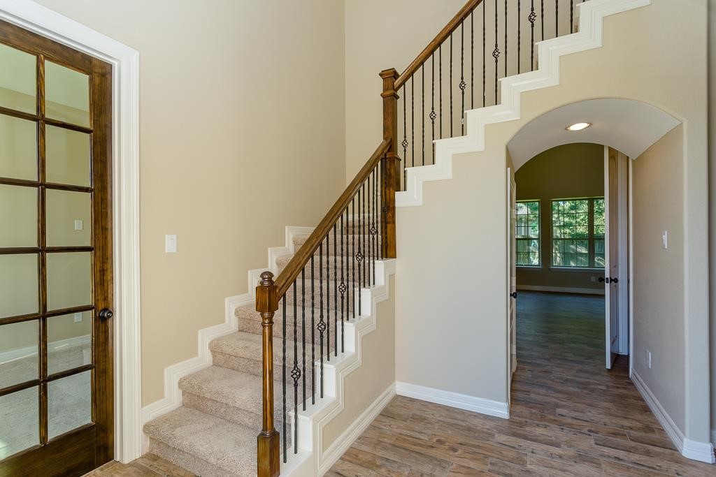 8403 Oak Knot Drive Spring, TX 77389 - Photo 4 of 31 a view of staircase with wooden floor and a window