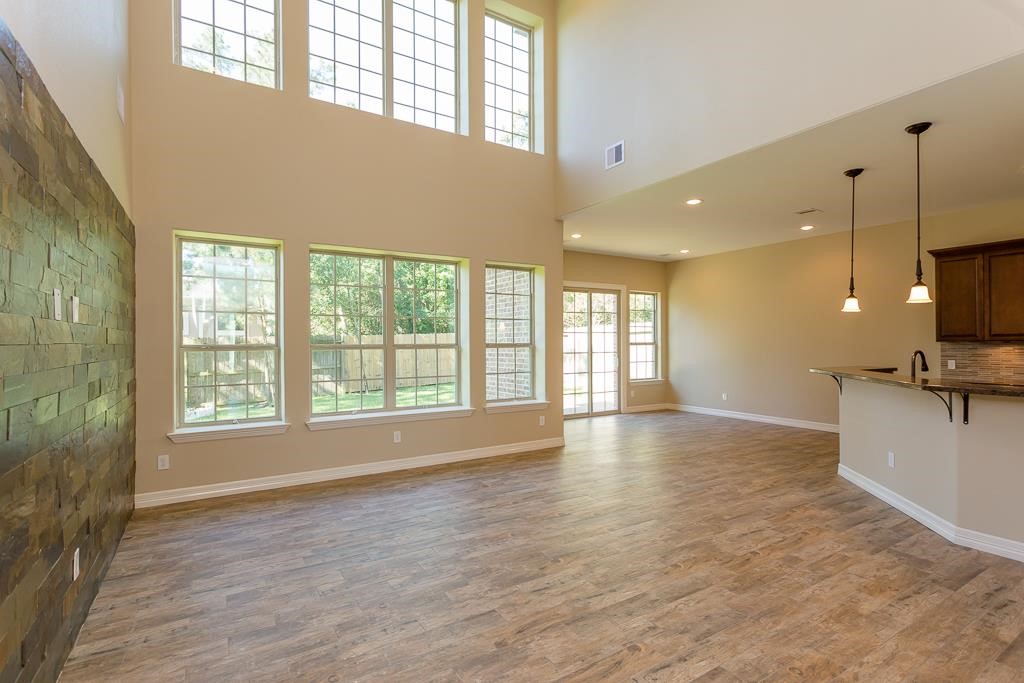 8403 Oak Knot Drive Spring, TX 77389 - Photo 9 of 31 a view of an empty room with a window and wooden floor