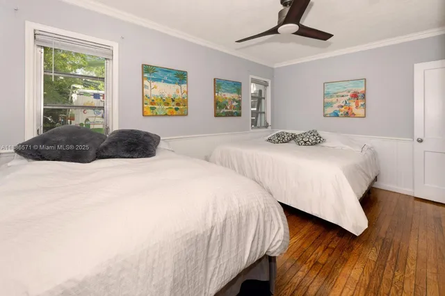 a bedroom with two beds and a window