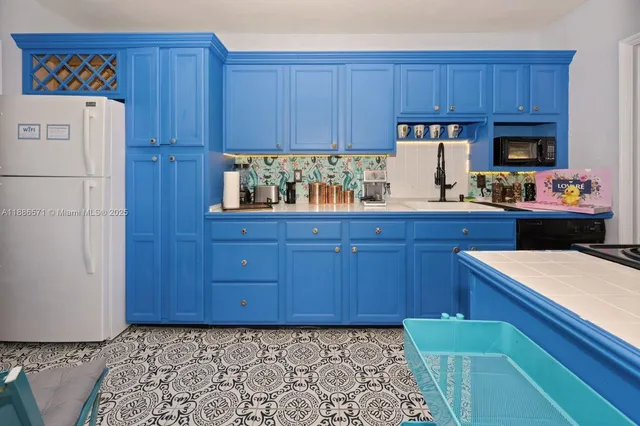 a kitchen with stainless steel appliances granite countertop a refrigerator and a stove