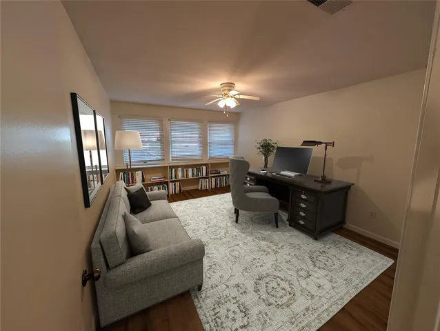 a living room with furniture and a piano