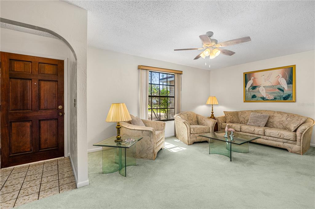 693 Reillys Road Port Orange, FL 32127 - Photo 11 of 31 a living room with furniture a lamp and a window
