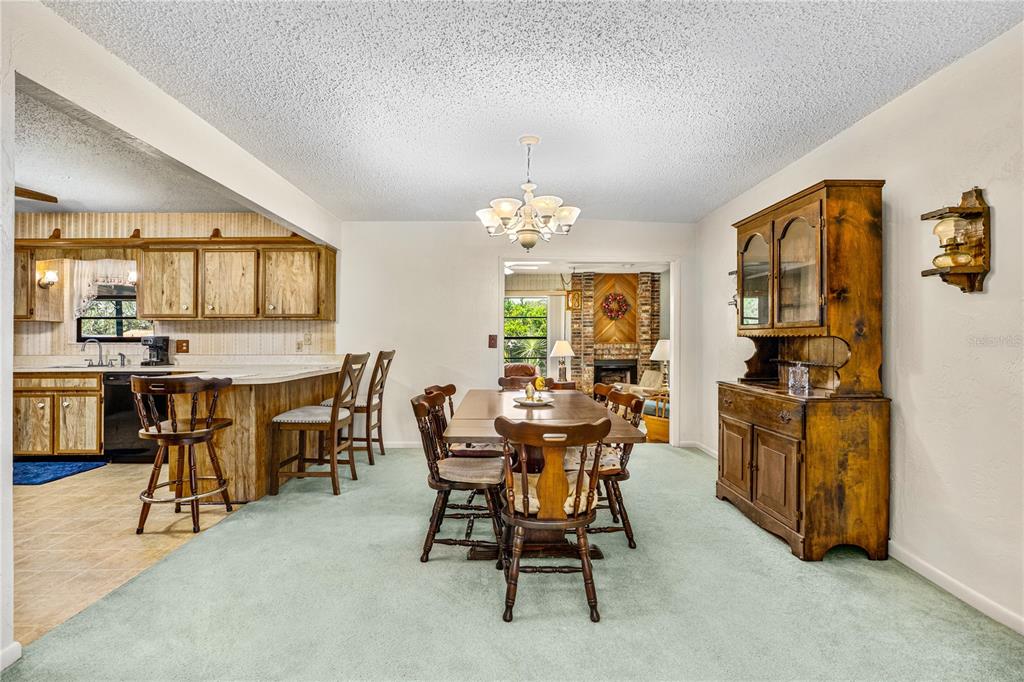 693 Reillys Road Port Orange, FL 32127 - Photo 15 of 31 a view of a dining room with furniture and a chandelier