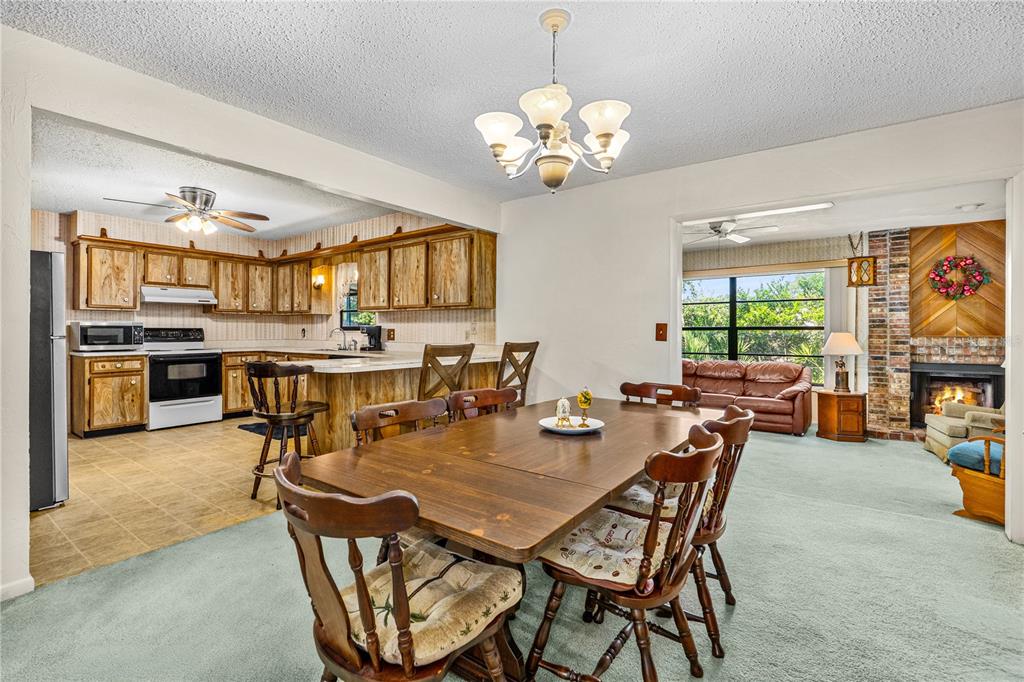 693 Reillys Road Port Orange, FL 32127 - Photo 16 of 31 a view of a dining room with furniture a chandelier and window