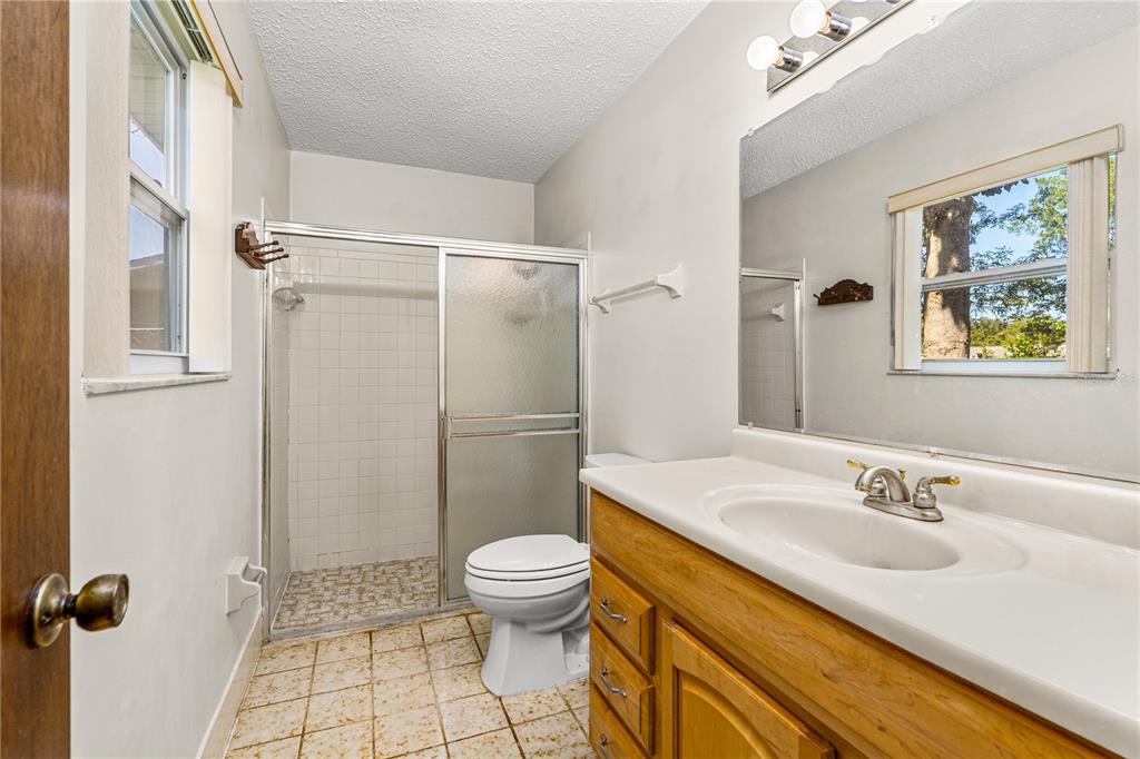 693 Reillys Road Port Orange, FL 32127 - Photo 20 of 31 a bathroom with a sink toilet and shower
