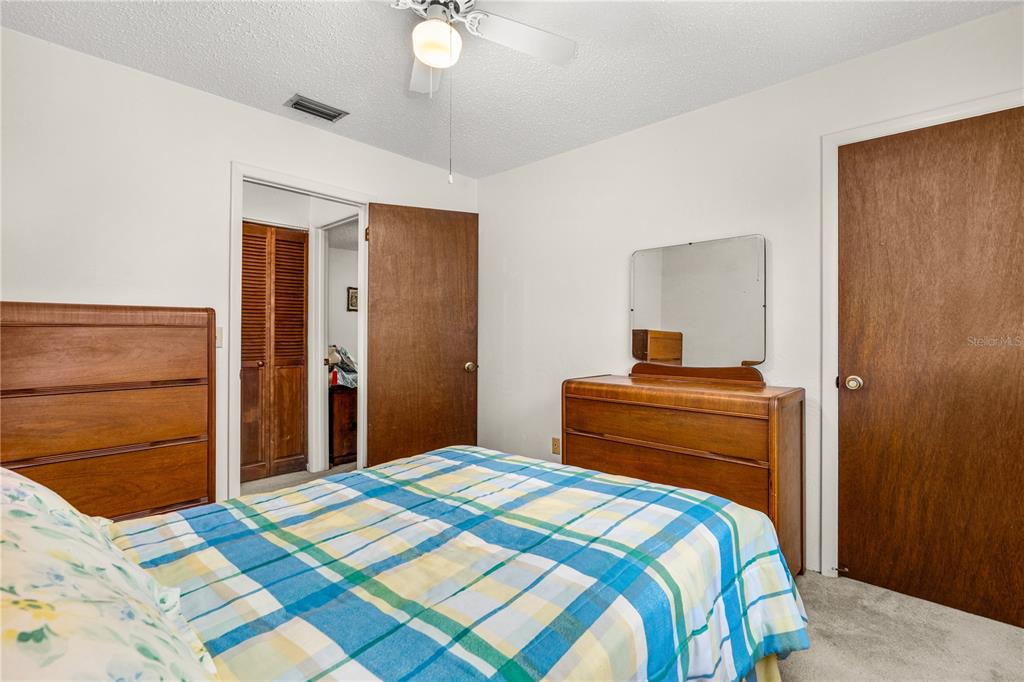 693 Reillys Road Port Orange, FL 32127 - Photo 25 of 31 a bedroom with a bed and a dresser