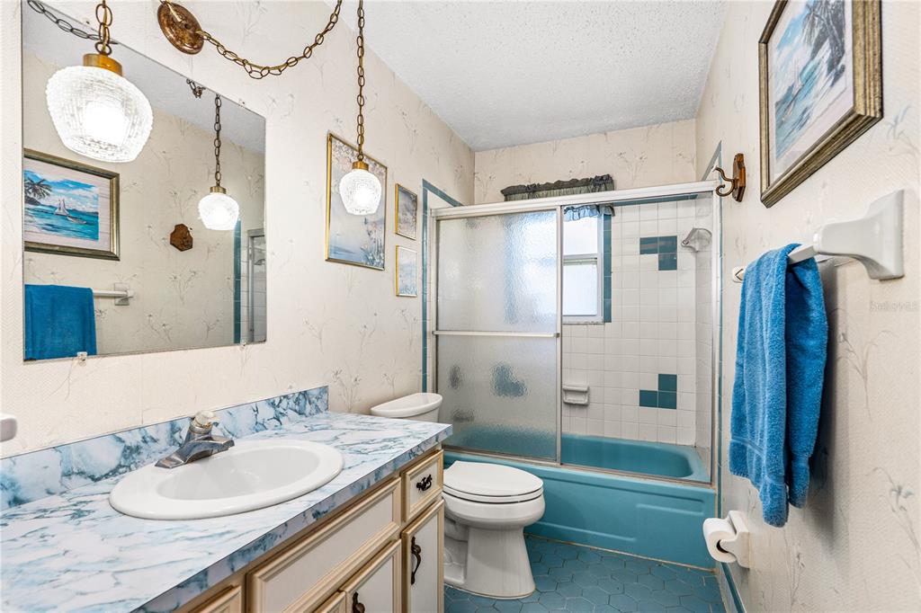 693 Reillys Road Port Orange, FL 32127 - Photo 26 of 31 a bathroom with a granite countertop sink toilet and shower