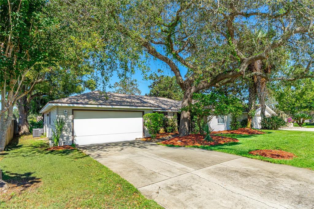 693 Reillys Road Port Orange, FL 32127 - Photo 3 of 31 a front view of a house with a yard and a trees