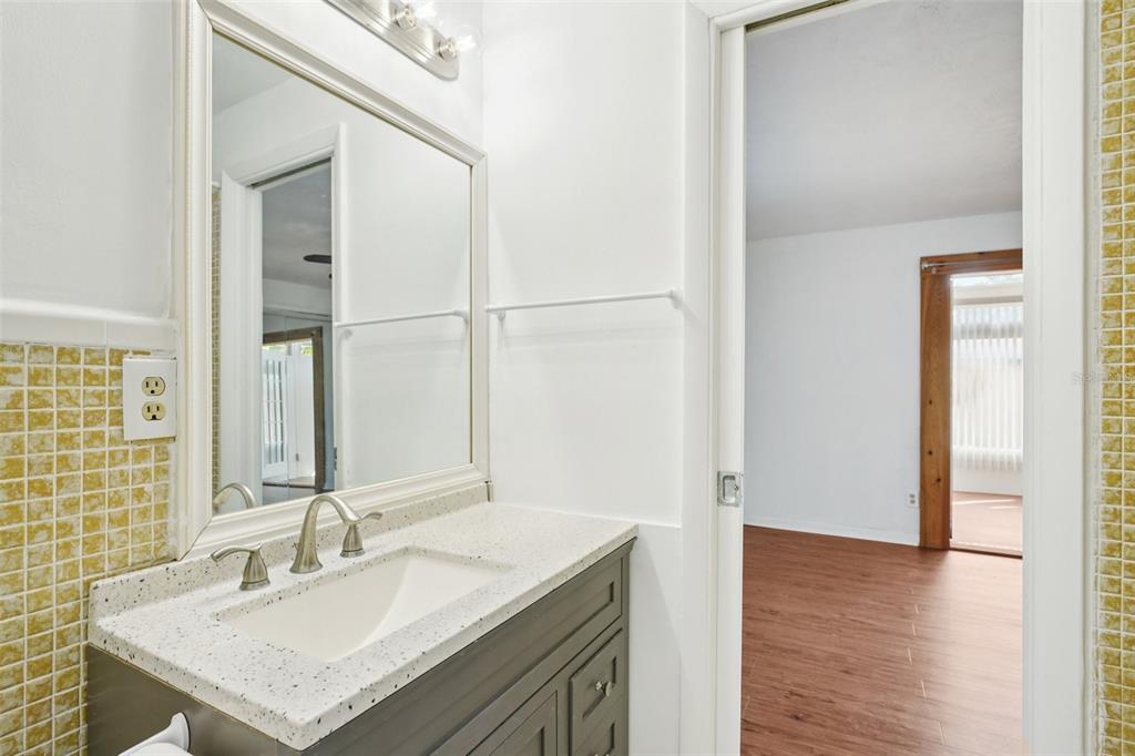 1975 Temple Terrace Clearwater, FL 33764 - Photo 30 of 69 a bathroom with a sink vanity granite and a mirror
