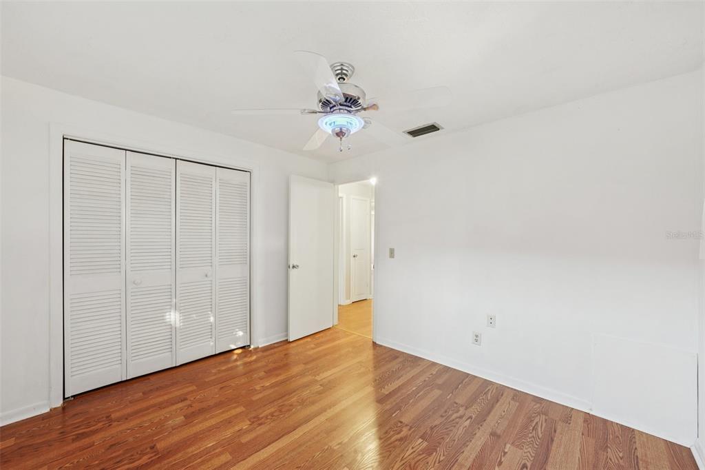 1975 Temple Terrace Clearwater, FL 33764 - Photo 32 of 69 a view of an empty room with wooden floor