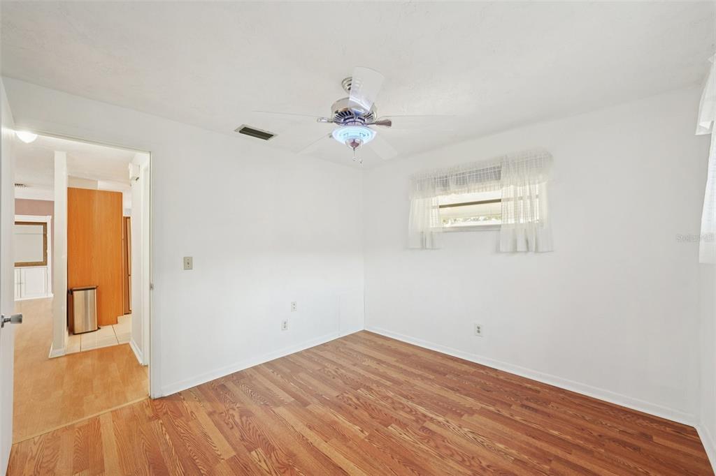 1975 Temple Terrace Clearwater, FL 33764 - Photo 33 of 69 a view of a room with wooden floor and ceiling fan