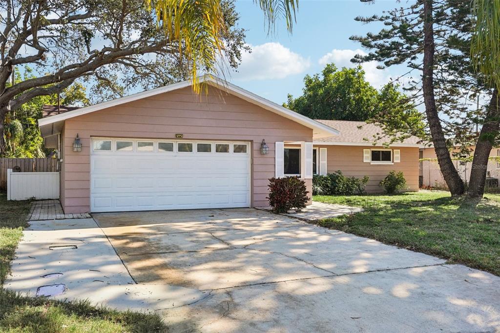 1975 Temple Terrace Clearwater, FL 33764 - Photo 55 of 69 a view of a house with a yard and garage