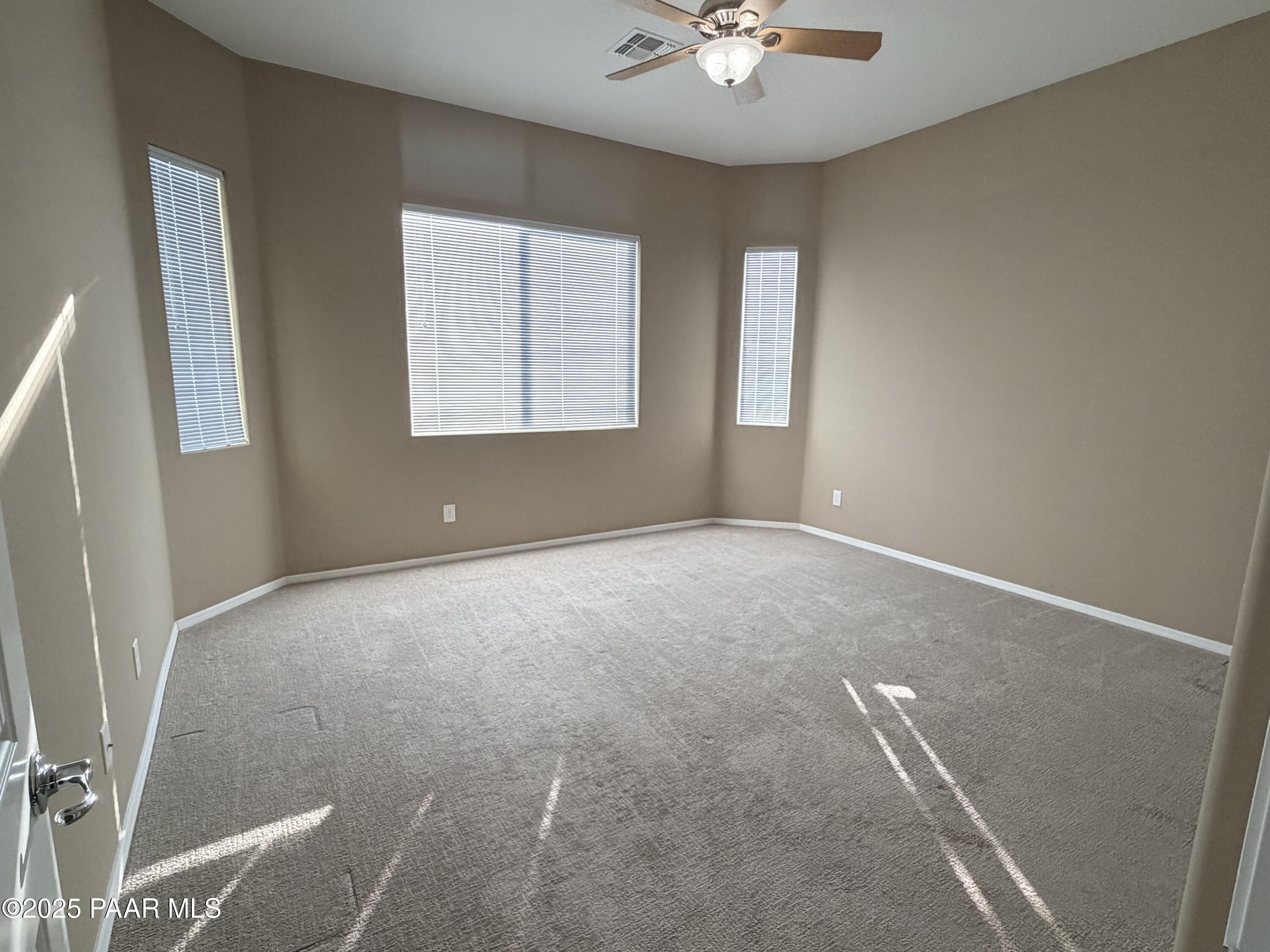 12937 East Sandoval Street Dewey, AZ 86327 - Photo 11 of 27 an empty room with windows and fan