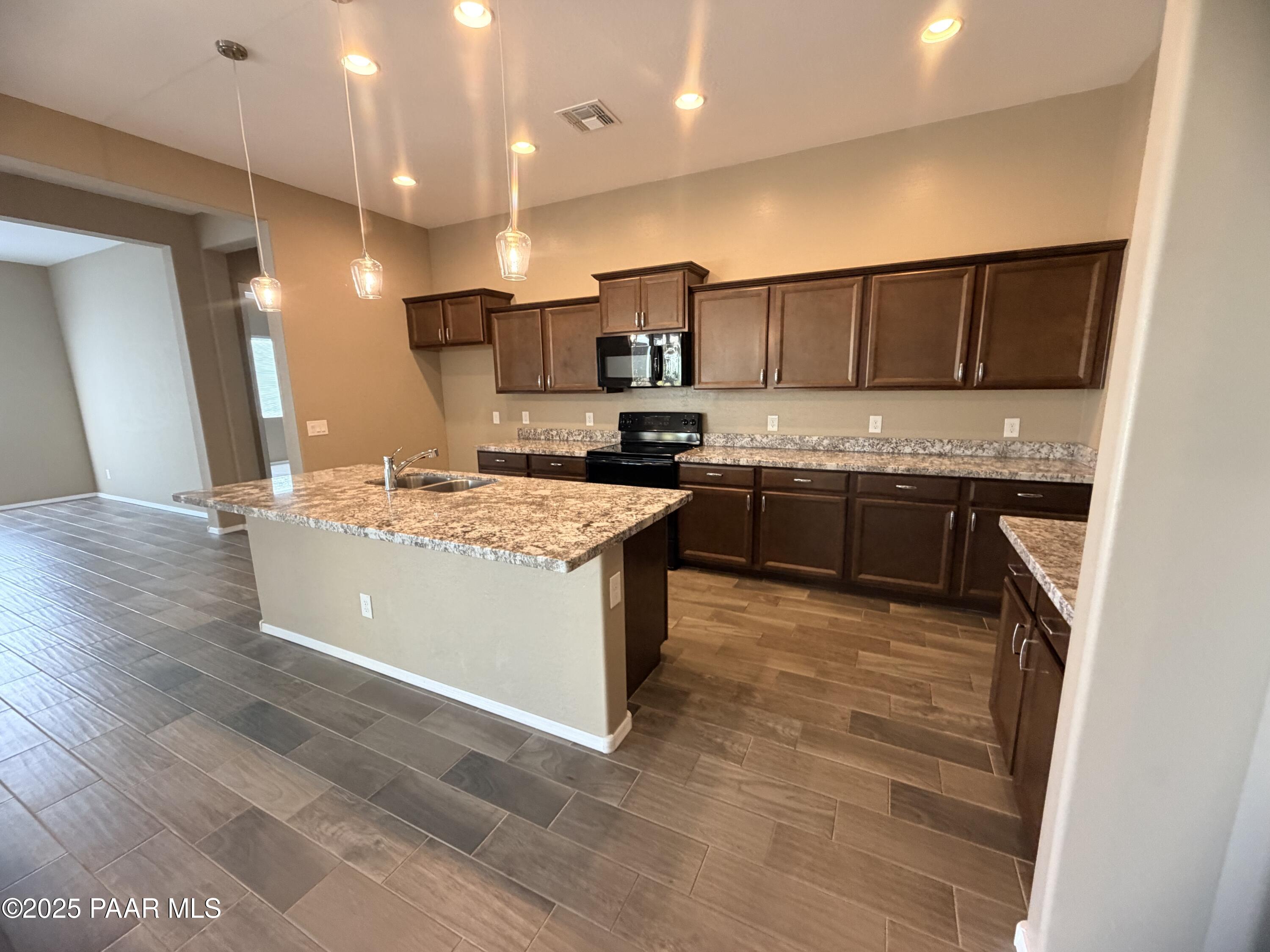 12937 East Sandoval Street Dewey, AZ 86327 - Photo 16 of 27 a kitchen with a sink stove and cabinets