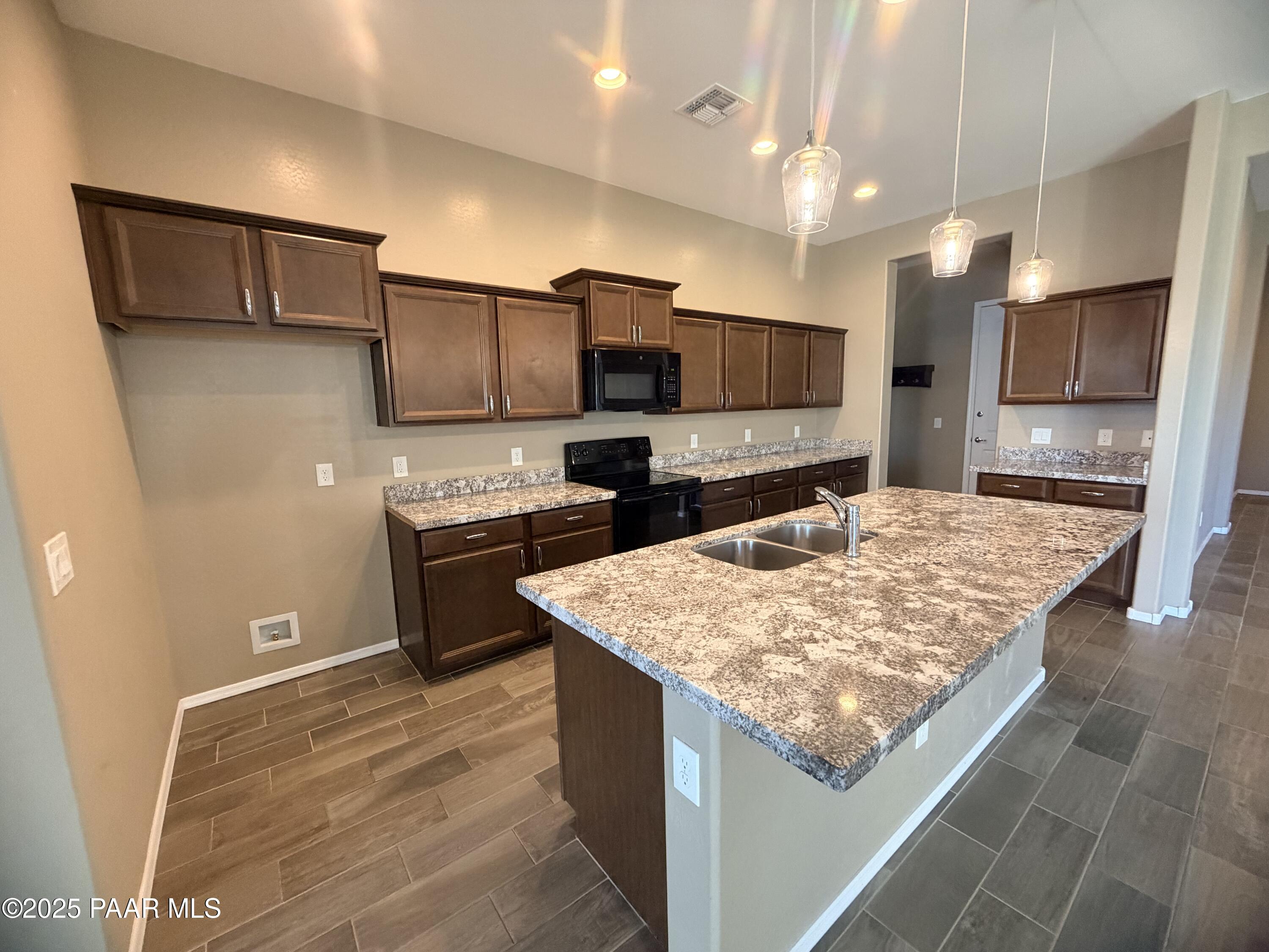 12937 East Sandoval Street Dewey, AZ 86327 - Photo 19 of 27 a kitchen with stainless steel appliances granite countertop a sink refrigerator and microwave