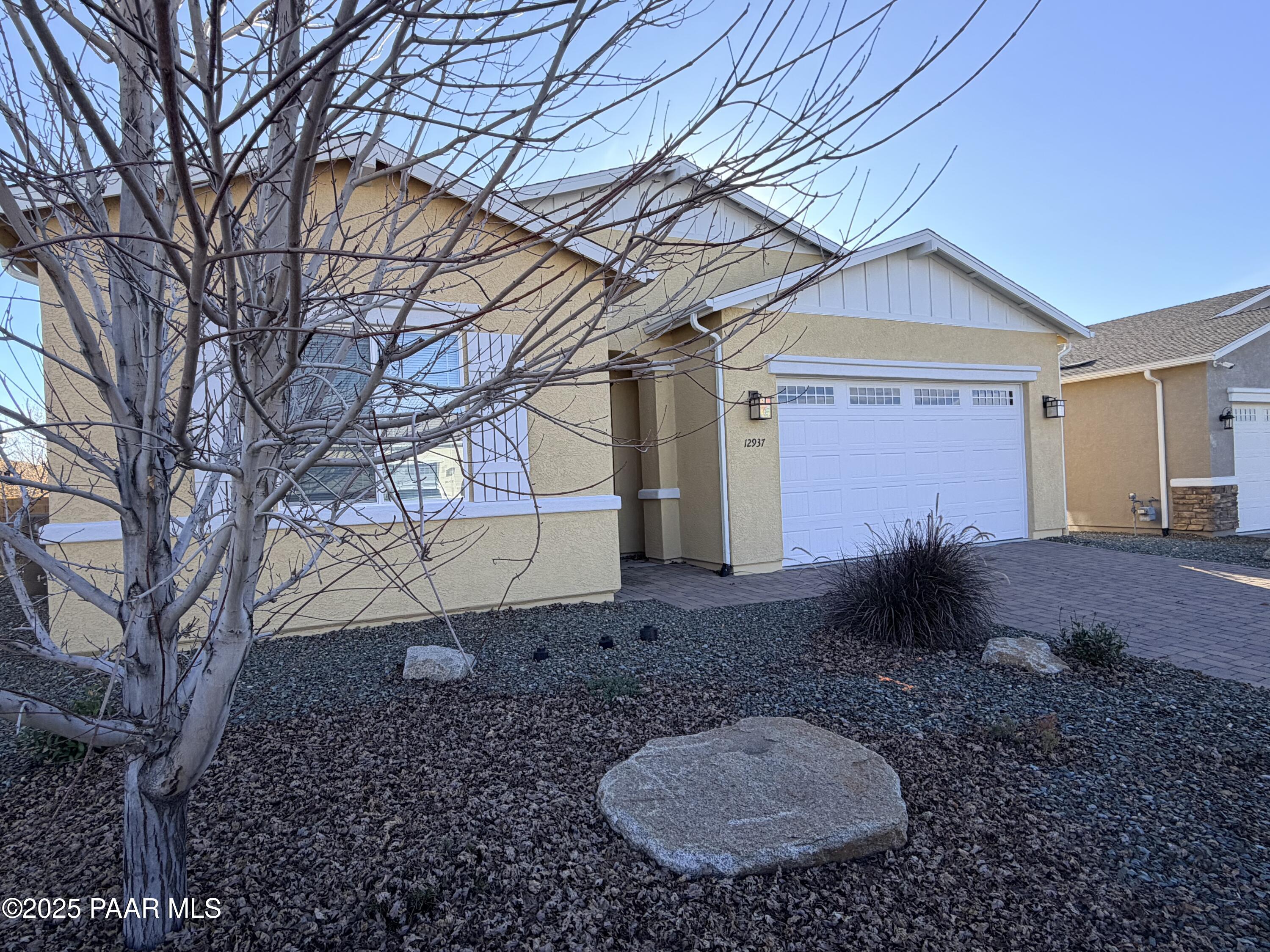 12937 East Sandoval Street Dewey, AZ 86327 - Photo 2 of 27 a view of a backyard with plants and large tree