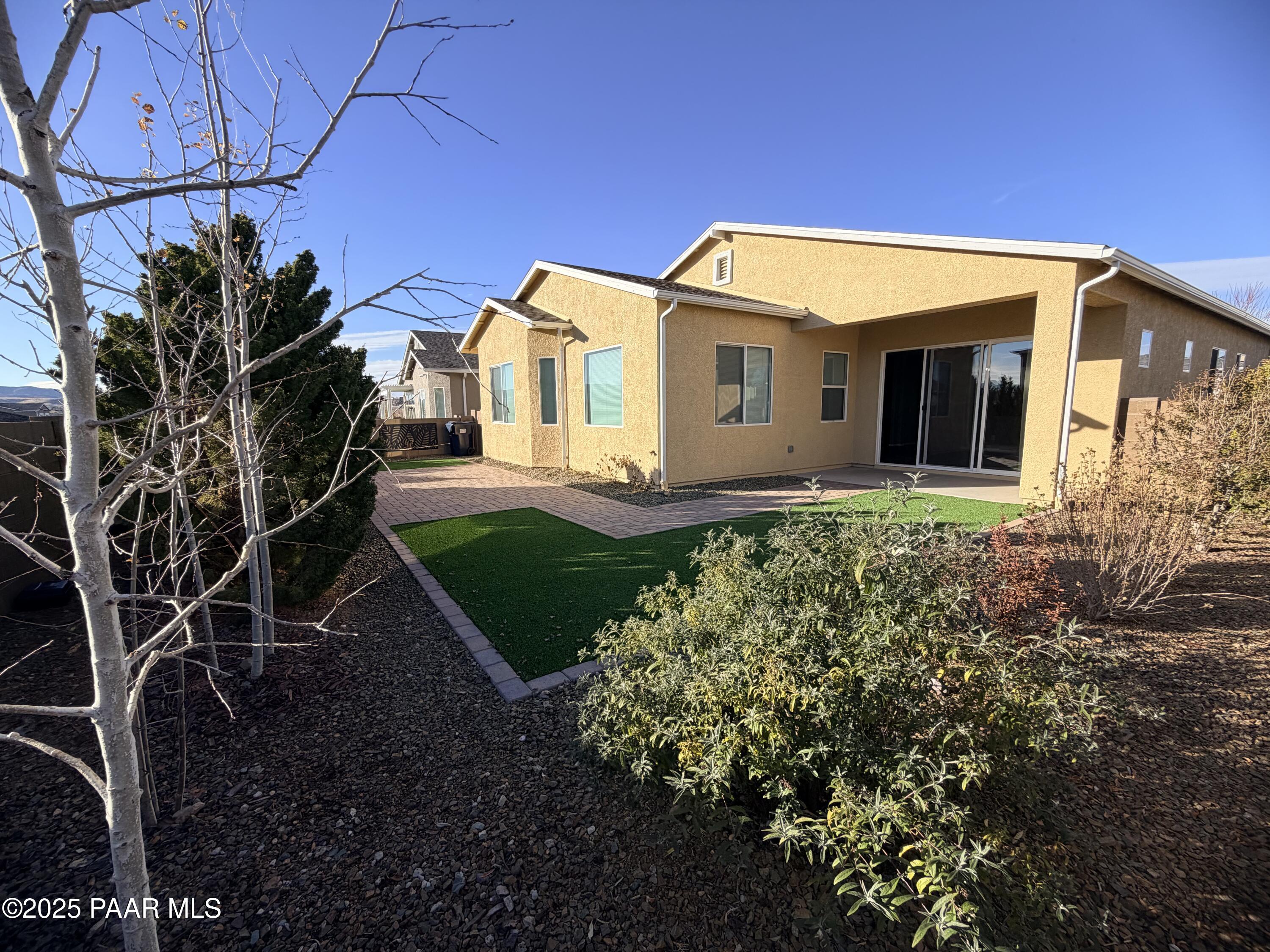 12937 East Sandoval Street Dewey, AZ 86327 - Photo 27 of 27 a view of a house with a small yard and plants
