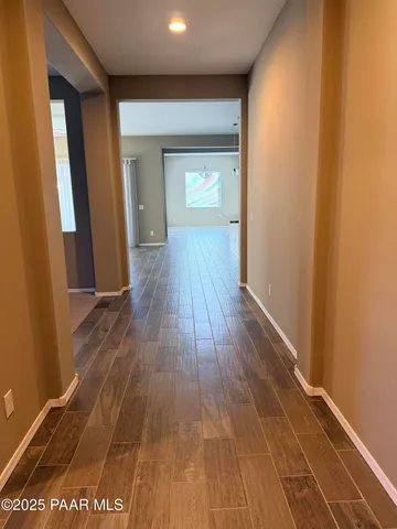 a view of a hallway with wooden floor