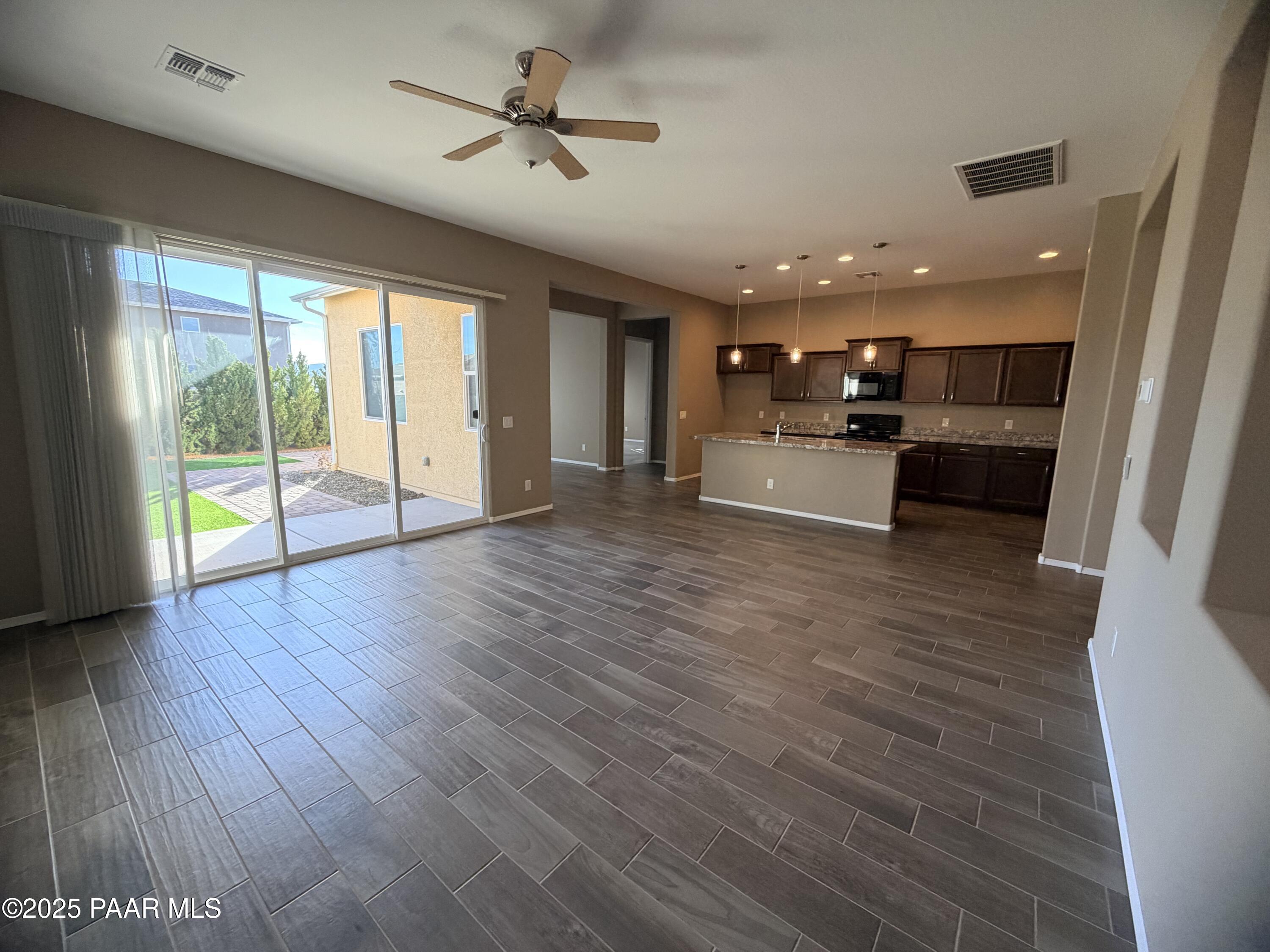 12937 East Sandoval Street Dewey, AZ 86327 - Photo 5 of 27 a large living room with stainless steel appliances wooden floors and view living room