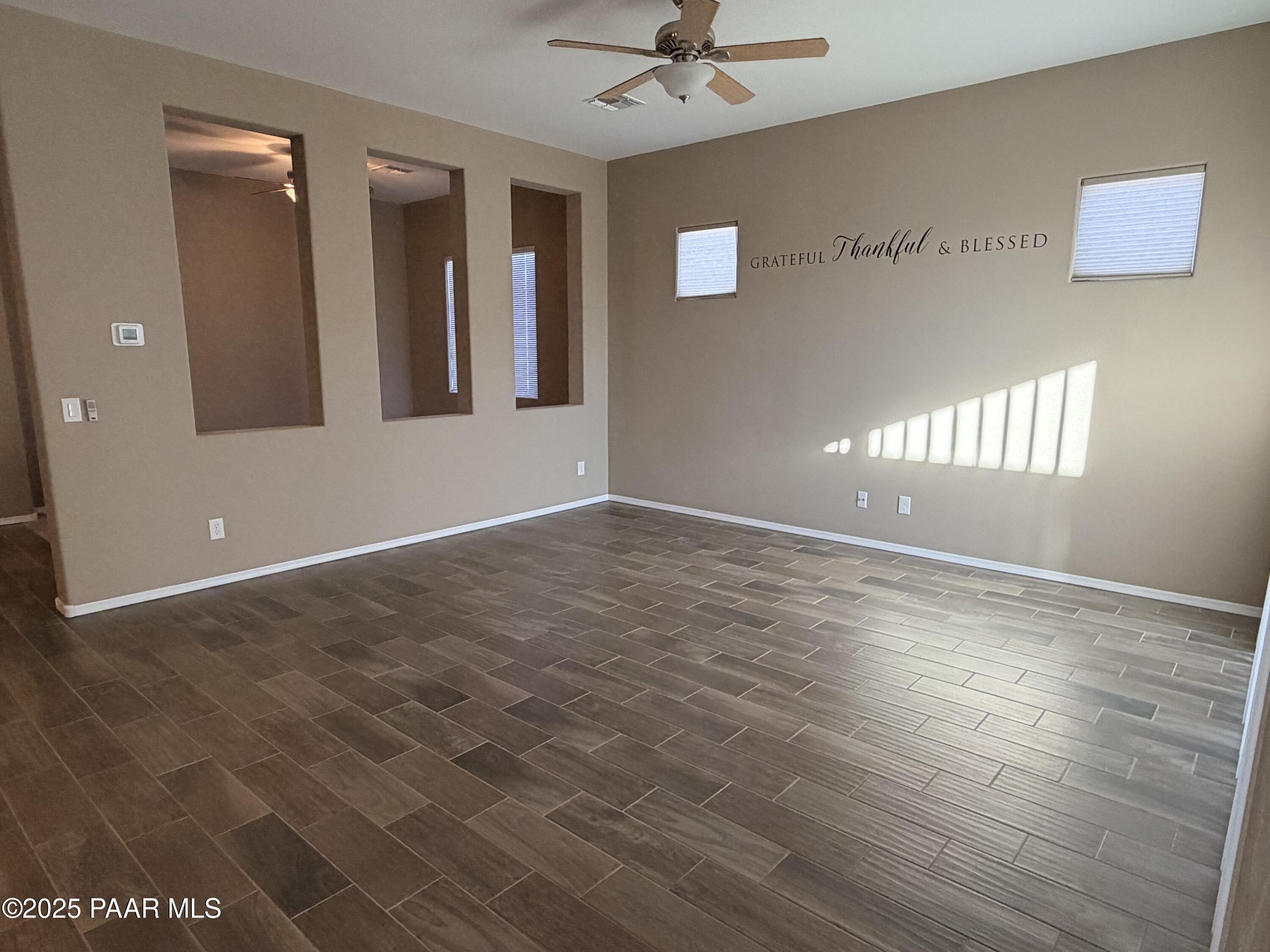 12937 East Sandoval Street Dewey, AZ 86327 - Photo 6 of 27 an empty room with wooden floor and windows