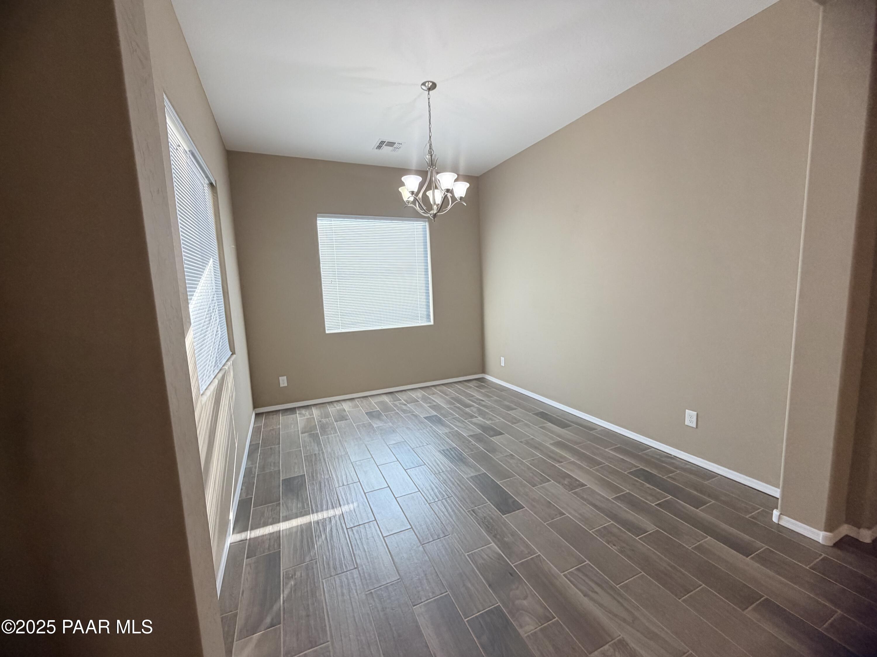 12937 East Sandoval Street Dewey, AZ 86327 - Photo 7 of 27 an empty room with wooden floor and windows