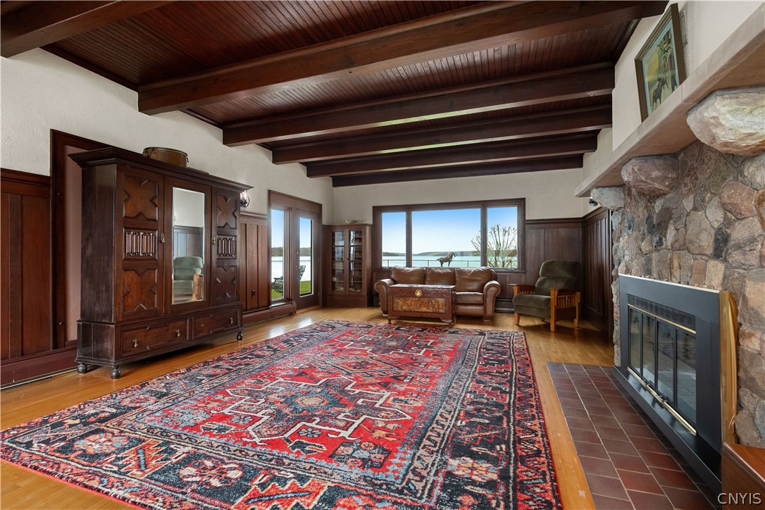 5072 West Lake Road Owasco, NY 13021 - Photo 4 of 50 Spacious living room with exposed wood beam ceilin