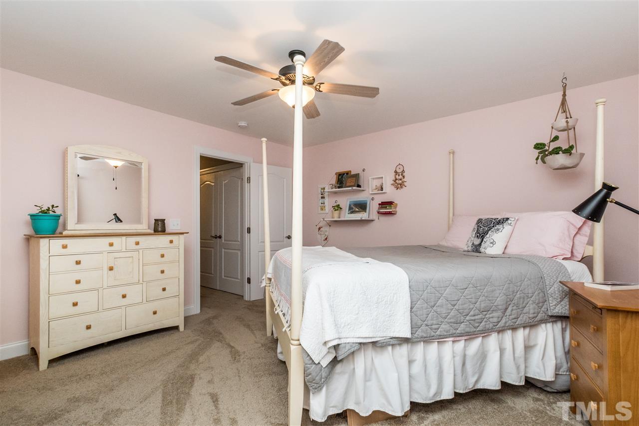 44 Henry Rifle Lane Angier, NC 27501 - Photo 14 of 22 a bedroom with a bed and a chandelier