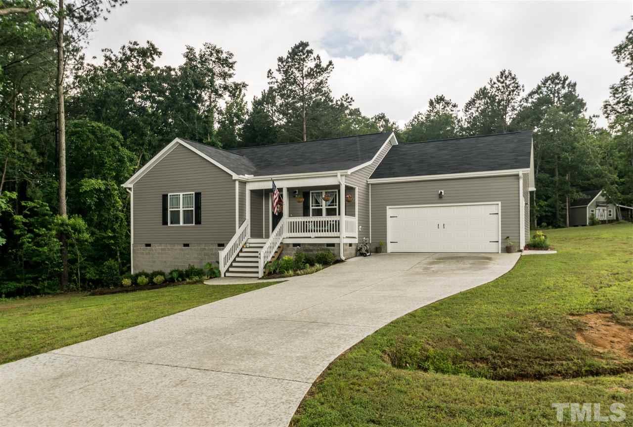44 Henry Rifle Lane Angier, NC 27501 - Photo 22 of 22 a front view of a house with a garden and trees