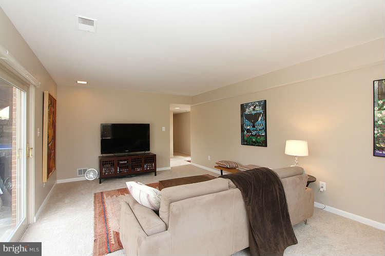 2411 Silver Fox Lane Reston, VA 20191 - Photo 22 of 30 a bedroom with a bed and a flat screen tv