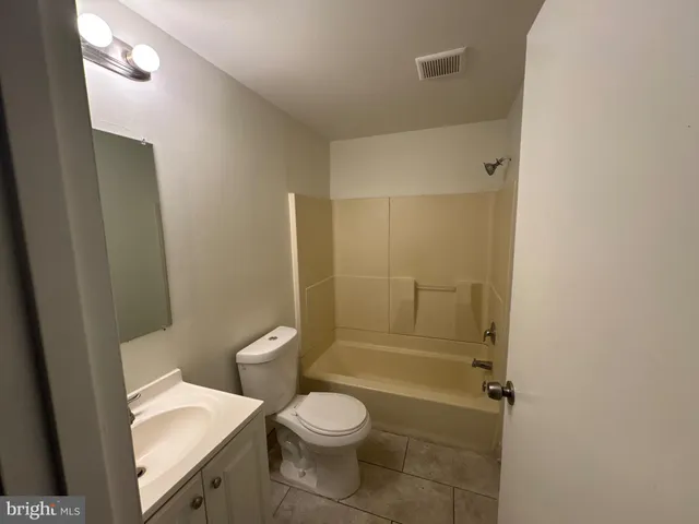 a bathroom with a toilet a sink and shower