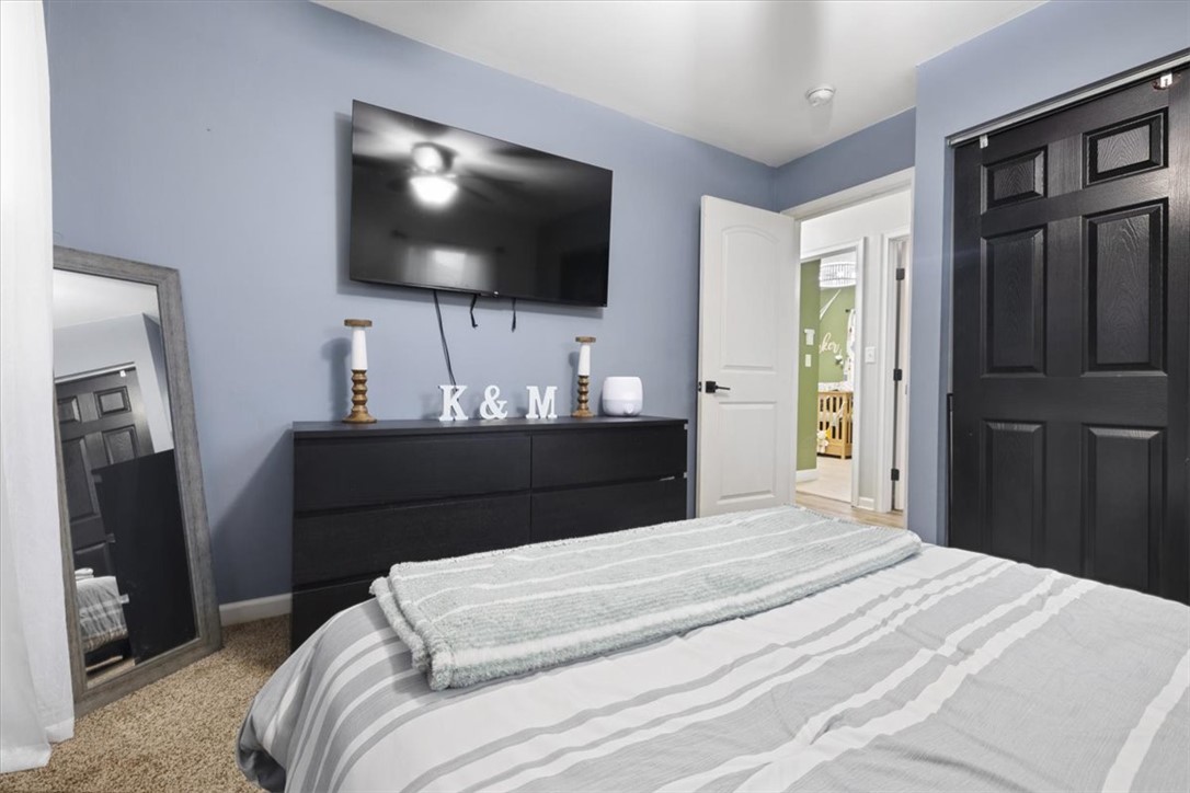 1482 Lee Road Troy, OH 45373 - Photo 16 of 30 This cozy bedroom features a stylish ceiling fan and soft carpeting, creating a tranquil retreat.