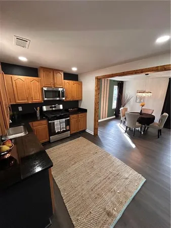 a kitchen with sink refrigerator and stove