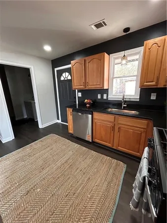 a kitchen with granite countertop sink cabinets and window