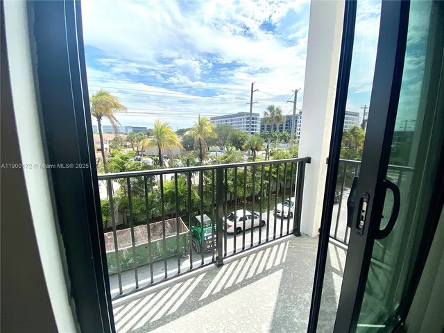 a view of a balcony with a floor to ceiling window