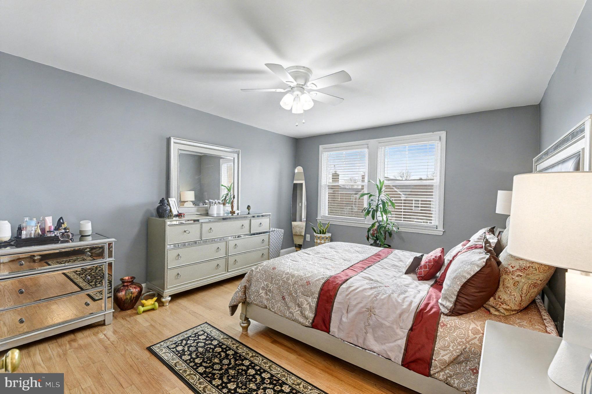 1510 Medford Road Baltimore, MD 21218 - Photo 14 of 30 a bedroom with a bed a chandelier and a window