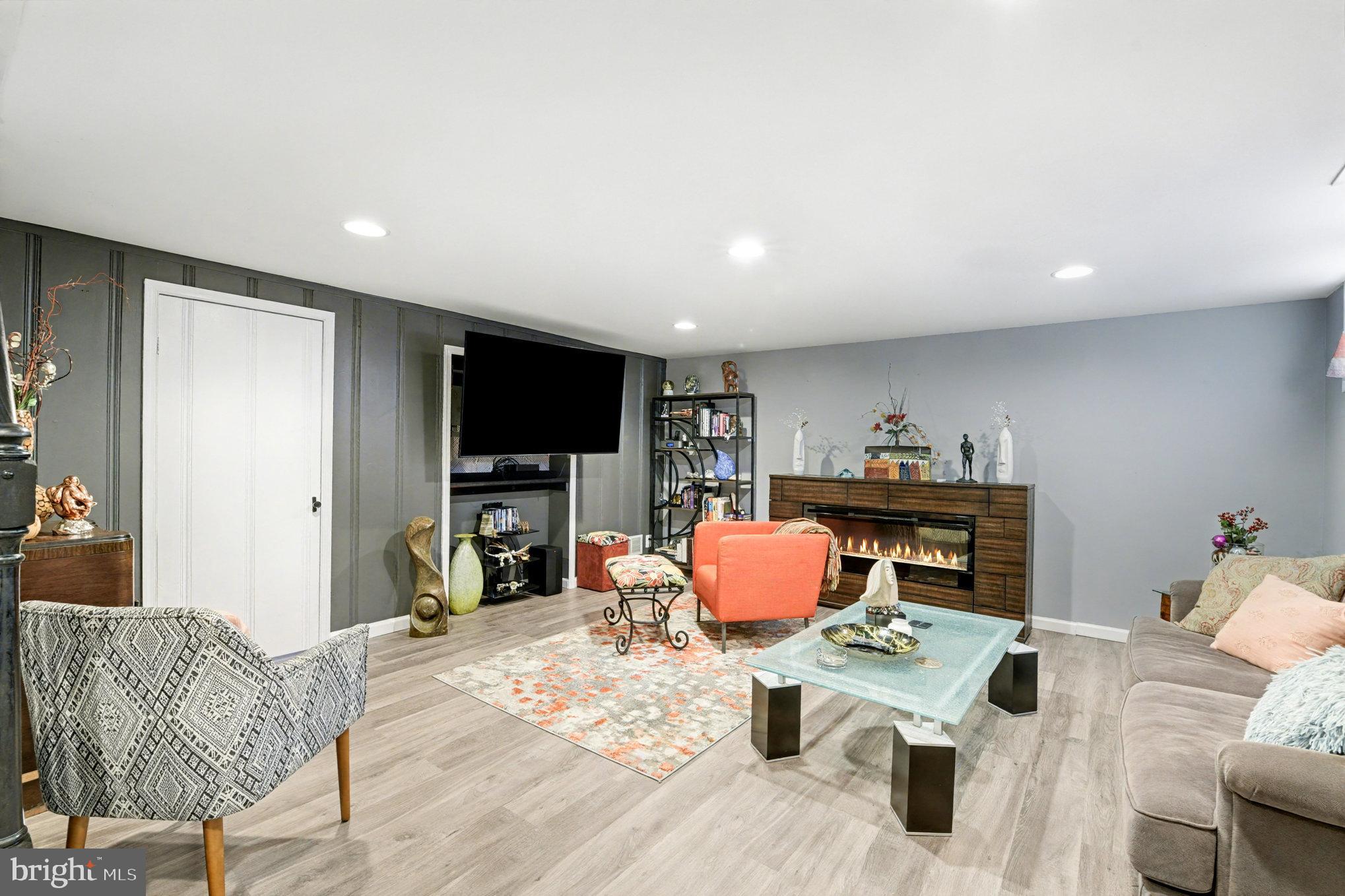 1510 Medford Road Baltimore, MD 21218 - Photo 22 of 30 a living room with furniture a flat screen tv and kitchen view