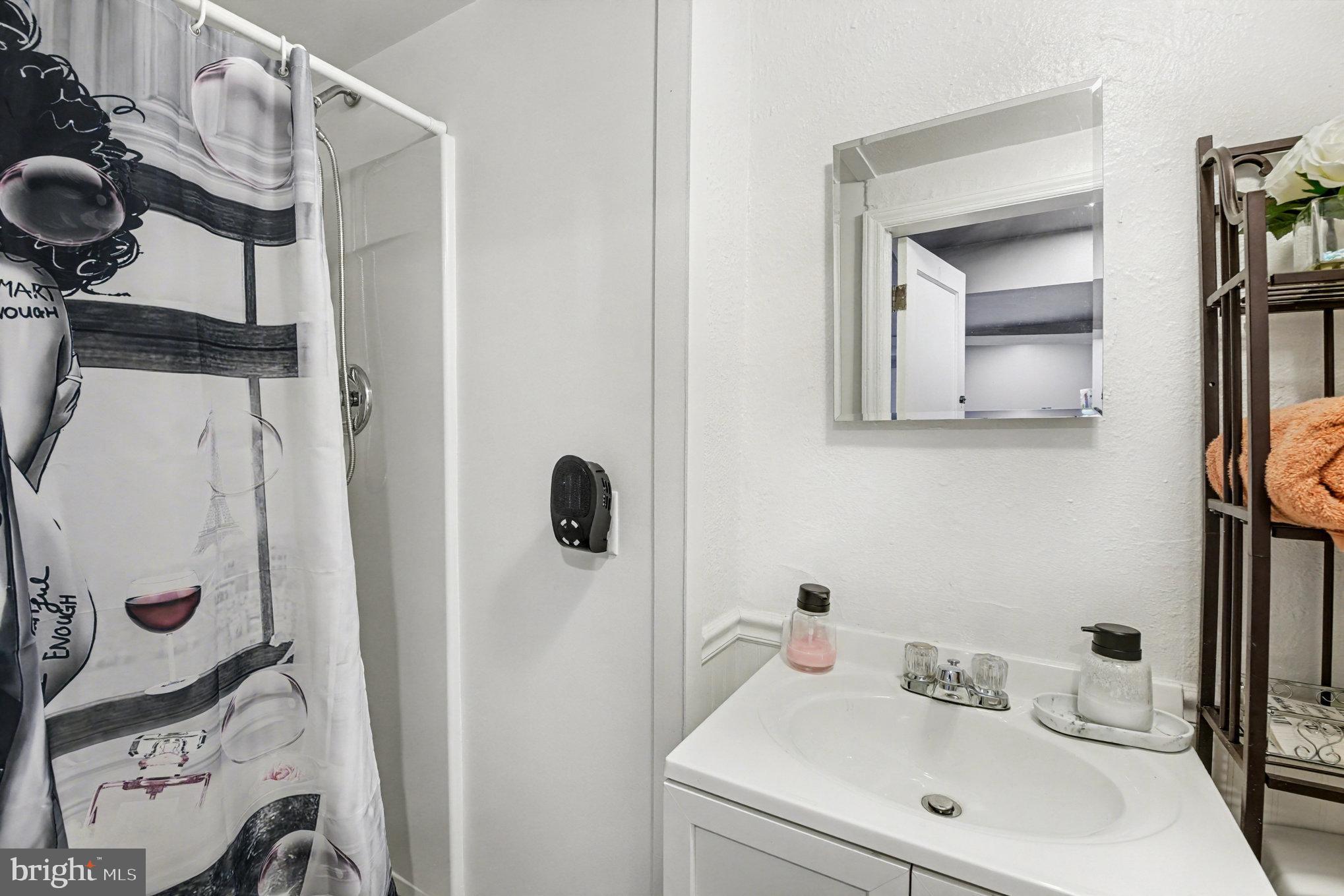 1510 Medford Road Baltimore, MD 21218 - Photo 23 of 30 a bathroom with a sink and mirror